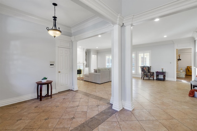 tiled entrance foyer featuring ornate columns and ornamental molding