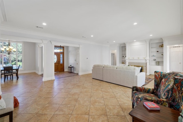 tiled living room with crown molding, a chandelier, and built in shelves