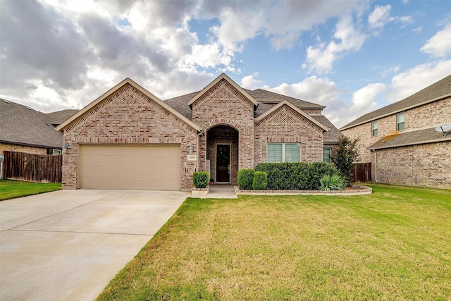 view of front of property with a garage and a front lawn