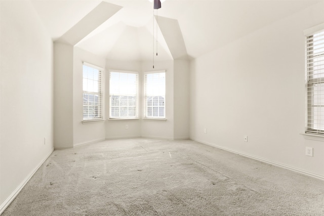 carpeted empty room featuring ceiling fan and lofted ceiling