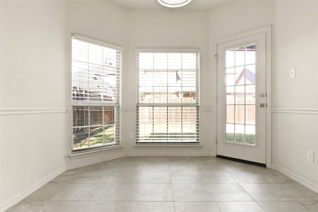 doorway to outside with a healthy amount of sunlight and light tile patterned floors