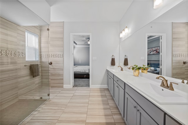 bathroom featuring vanity, tiled shower, ceiling fan, and tile patterned floors