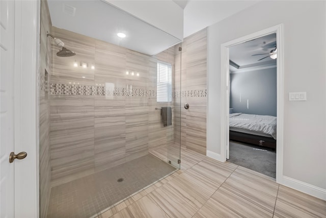 bathroom featuring ceiling fan, tile patterned floors, and tiled shower