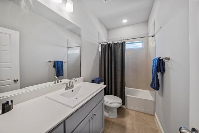 full bathroom with vanity, toilet, tile patterned floors, and shower / bath combo with shower curtain