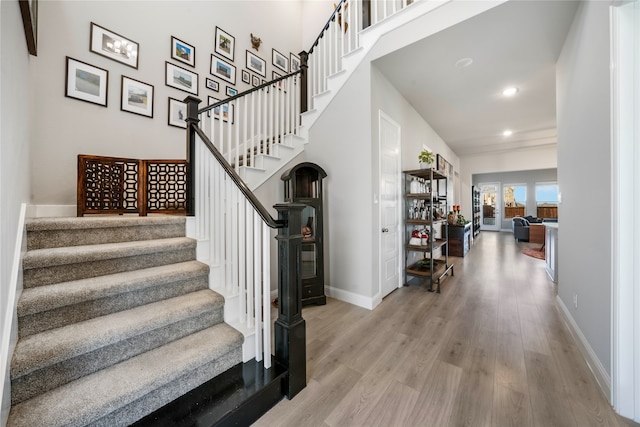 stairway with hardwood / wood-style floors