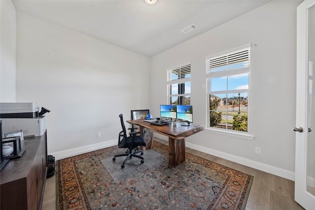 office space with hardwood / wood-style flooring