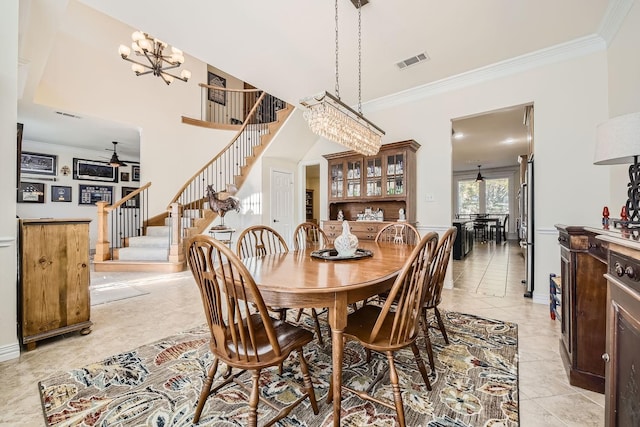dining space with visible vents, light tile patterned floors, crown molding, stairs, and ceiling fan with notable chandelier