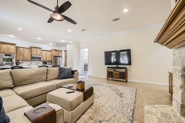 living room featuring ornamental molding, a stone fireplace, light tile patterned floors, and ceiling fan