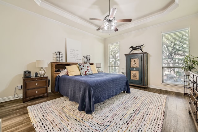 bedroom with ceiling fan, multiple windows, and dark hardwood / wood-style flooring