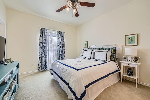 bedroom featuring light carpet, baseboards, and ceiling fan