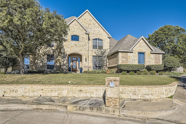 french country inspired facade with a front lawn