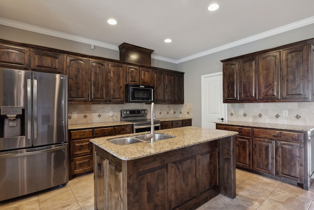 kitchen with backsplash, appliances with stainless steel finishes, an island with sink, light stone countertops, and dark brown cabinetry