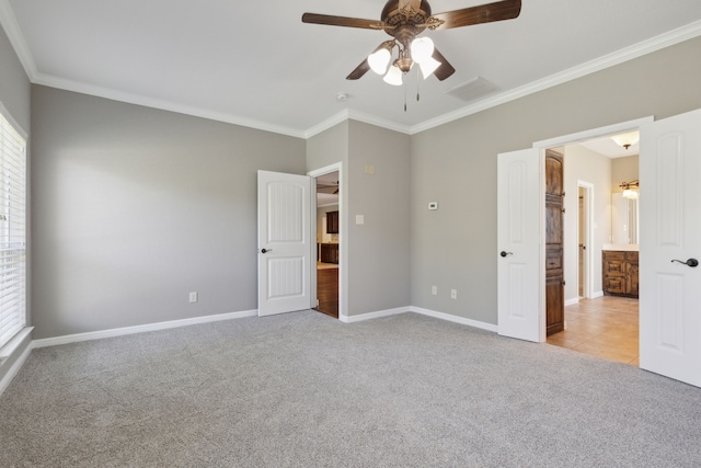 unfurnished bedroom with ceiling fan, light carpet, and crown molding