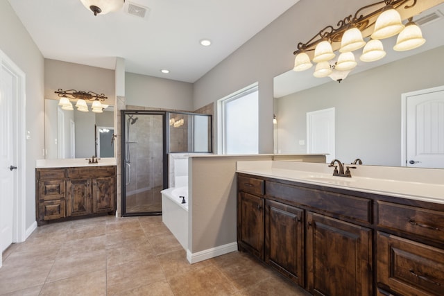 bathroom featuring vanity, plus walk in shower, and tile patterned flooring