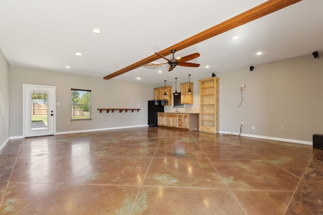 unfurnished living room featuring ceiling fan and beamed ceiling