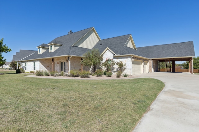 view of front facade with a front yard, a garage, and a carport