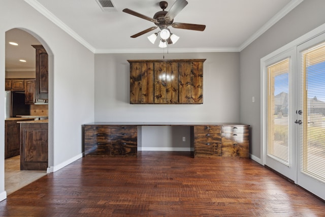 unfurnished dining area with ornamental molding, dark hardwood / wood-style floors, and built in desk