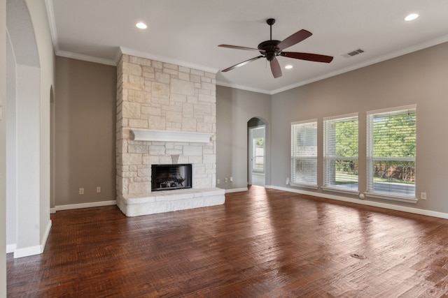 unfurnished living room with ornamental molding, dark wood-type flooring, a fireplace, and ceiling fan