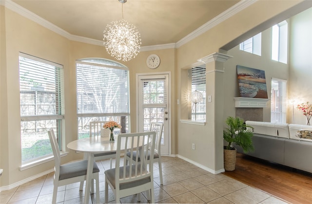 dining space with a wealth of natural light, crown molding, and light tile patterned floors