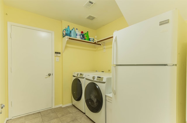 laundry room with light tile patterned flooring and independent washer and dryer