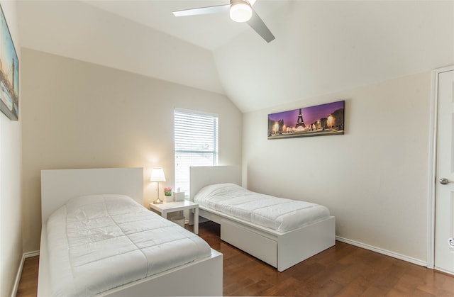 bedroom with dark hardwood / wood-style flooring, vaulted ceiling, and ceiling fan