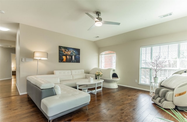 living room featuring vaulted ceiling, dark hardwood / wood-style floors, and ceiling fan