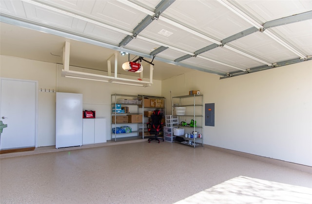 garage featuring a garage door opener and electric panel