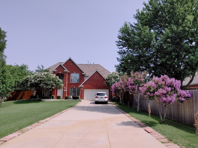 view of front of property featuring a front yard and a garage