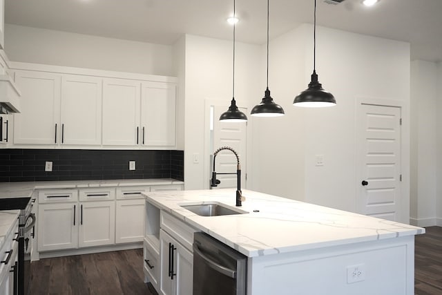 kitchen with appliances with stainless steel finishes, sink, an island with sink, white cabinets, and dark wood-type flooring