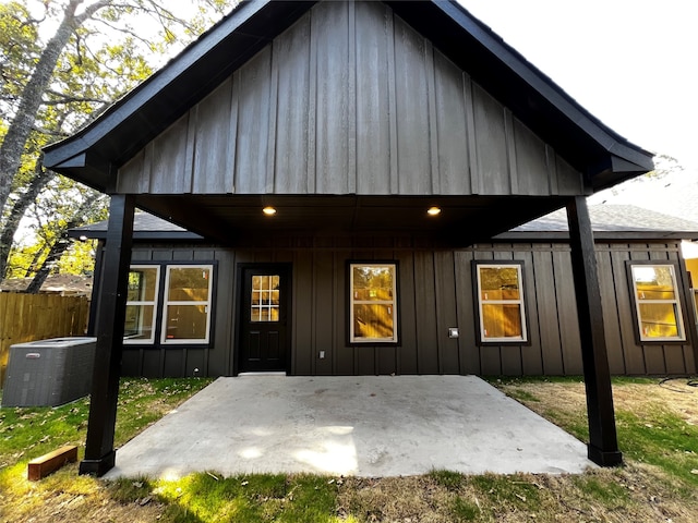 back of house with central air condition unit and a patio