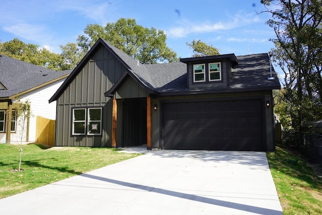 view of front facade with a front yard and a garage