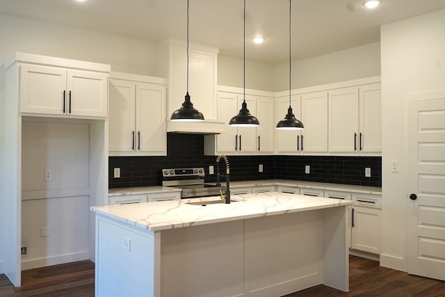 kitchen featuring dark wood-type flooring, light stone countertops, a kitchen island with sink, and white cabinetry