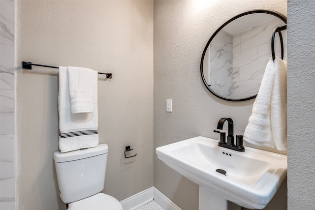 bathroom featuring toilet and sink