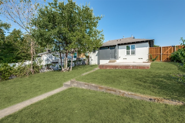 back of property featuring a patio and a lawn