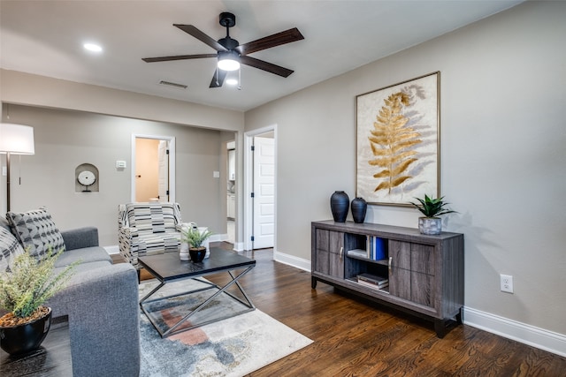 living room with dark wood-type flooring and ceiling fan