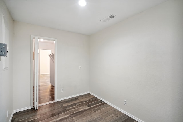 unfurnished room featuring dark wood-type flooring