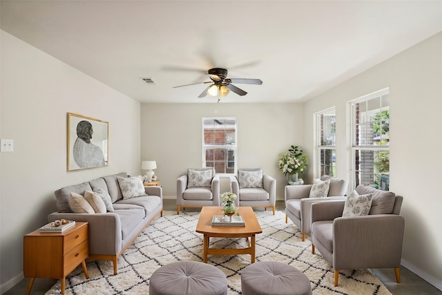 living room featuring ceiling fan and a healthy amount of sunlight