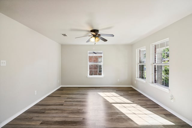 spare room featuring ceiling fan and dark hardwood / wood-style flooring