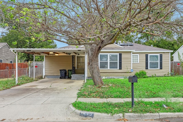 view of front of property featuring a front yard and a carport