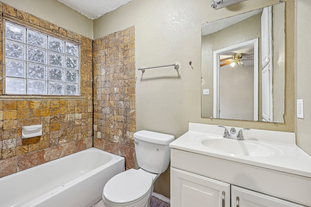 bathroom with ceiling fan, vanity, toilet, and a textured ceiling