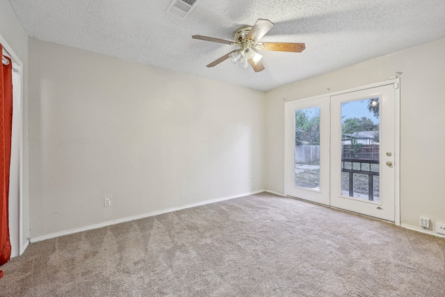 empty room featuring carpet flooring, french doors, a textured ceiling, and ceiling fan