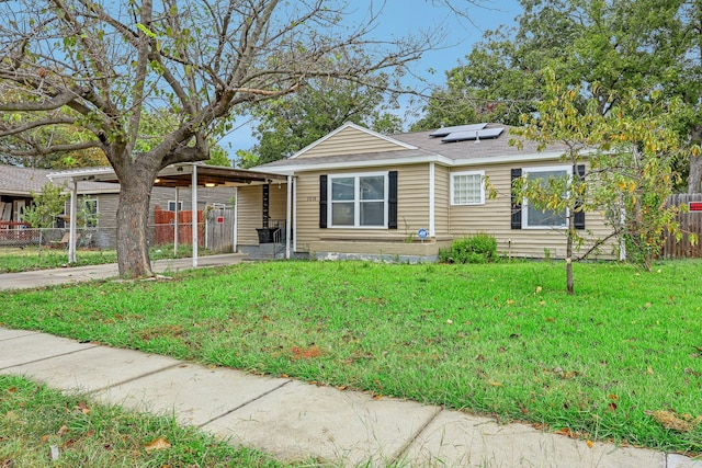 bungalow featuring a carport and a front yard