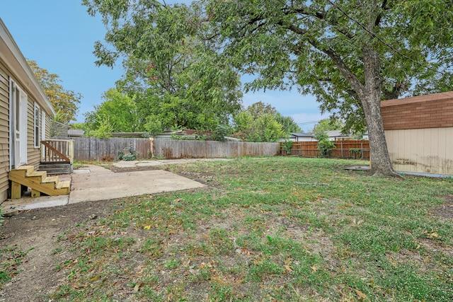 view of yard featuring a shed and a patio