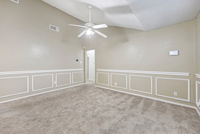 unfurnished room with a textured ceiling, light carpet, and ceiling fan