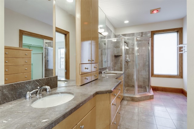 bathroom with vanity, an enclosed shower, tile patterned flooring, and a wealth of natural light