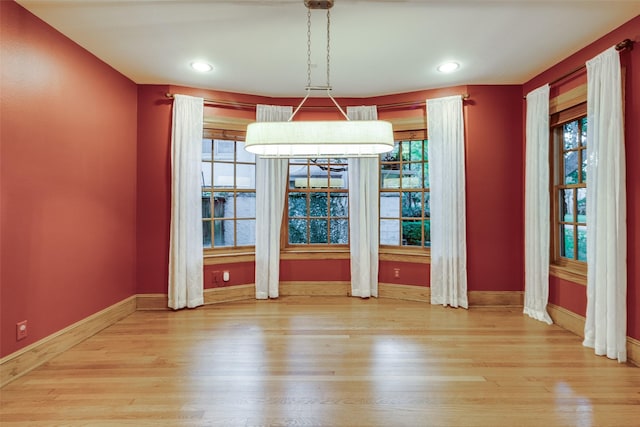 unfurnished dining area featuring hardwood / wood-style floors and a wealth of natural light