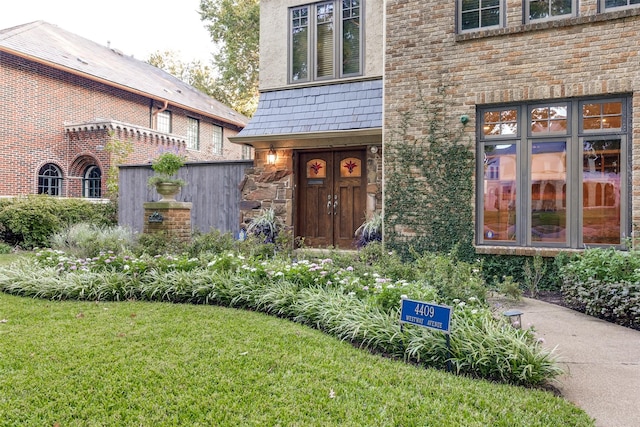 entrance to property with a lawn