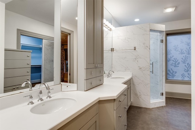 bathroom with vanity and a shower with door