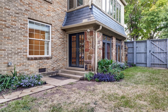 doorway to property with a yard and french doors