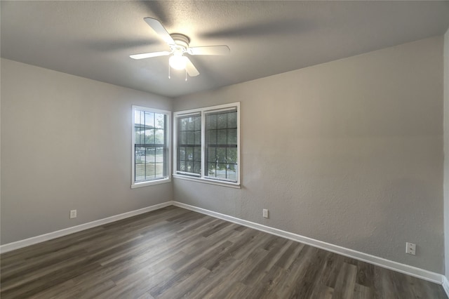 spare room featuring ceiling fan and dark wood-type flooring